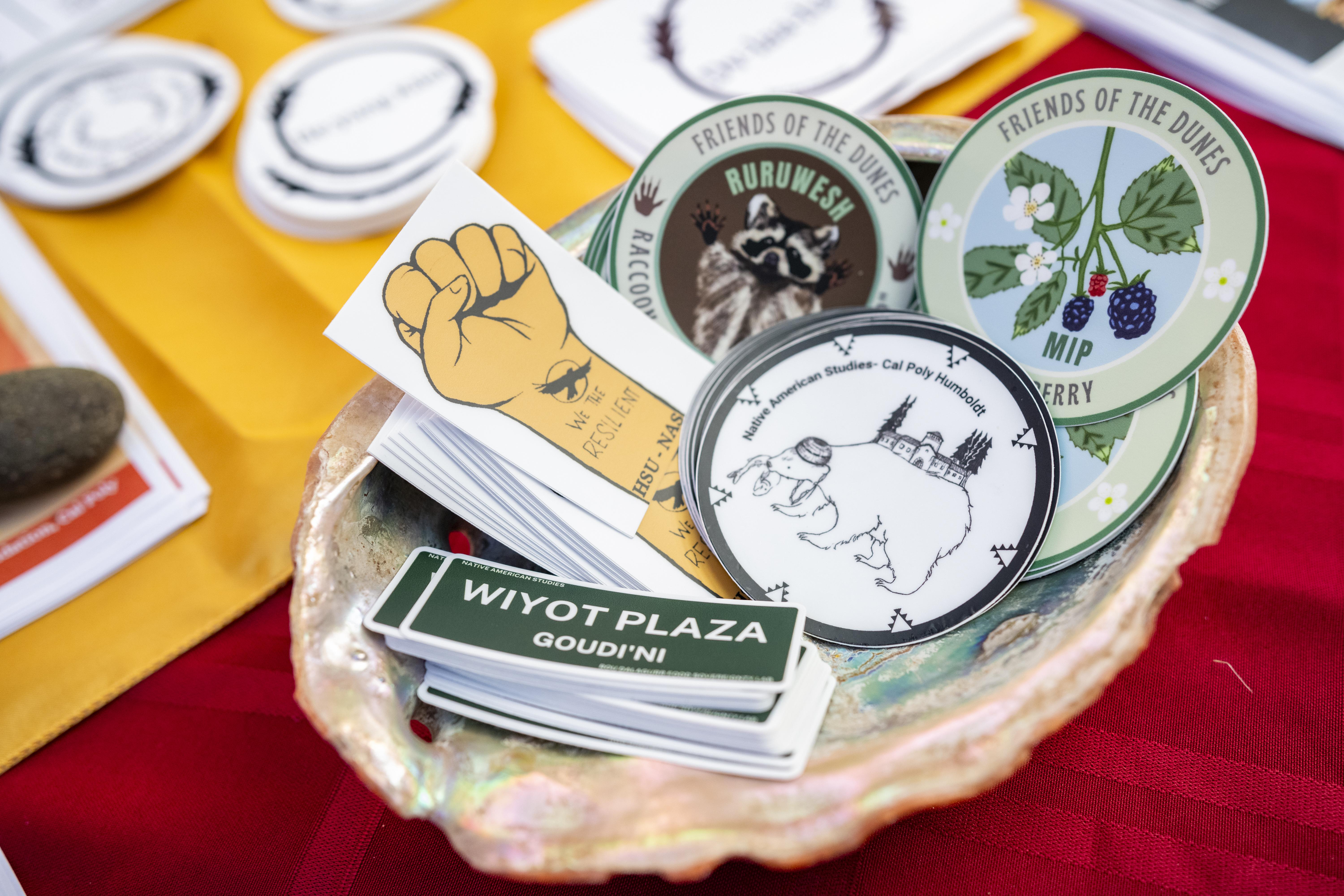 Various Stickers laid in an Abalone Shell on a table